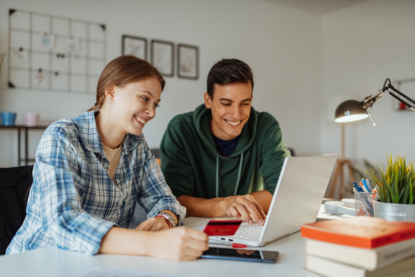 Couple at home using credit card for online shopping